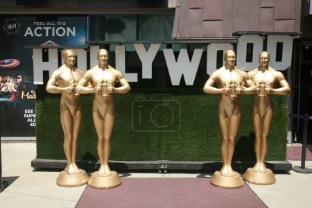 Photo for Hollywood, California USA - May 12, 2023: The Oscar statue. Tourist enjoy Posing with Life Size Oscar Statues for Photos. The Academy Award of Merit. World Famous Oscar Statue to pose with for fun. - Royalty Free Image