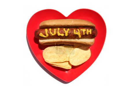Photo for Hotdog. Mustard on patriotic hot dog. 4th of July Hot Dog. 4th of July written in Yellow Mustard on a Hotdog. USA Patriotic picnic holiday hotdogs. - Royalty Free Image