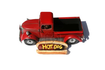 Photo for Hotdog with the words HOT DOG written in Yellow Mustard. Hotdogs for Lunch. Isolated on white. Hotdog in a red truck in its bun. - Royalty Free Image