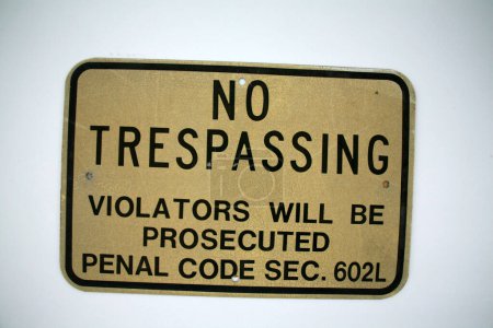 Photo for NO TRESPASSING. An old No Trespassing metal sign. Isolated on white. Room for text. Reflective Warning No Trespassing Sign. No Trespassing. Violators will be Prosecuted. Penal code sec. 602L. Warning. - Royalty Free Image