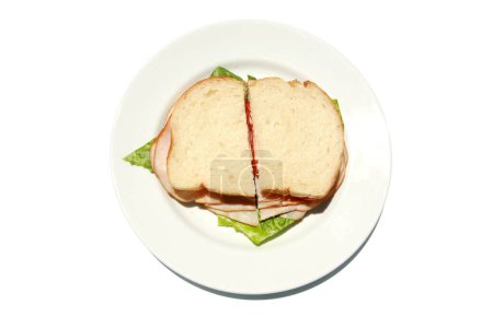 Foto de Sandwich casero con pavo ahumado, lechuga, tomate y queso en plato blanco aislado - Imagen libre de derechos