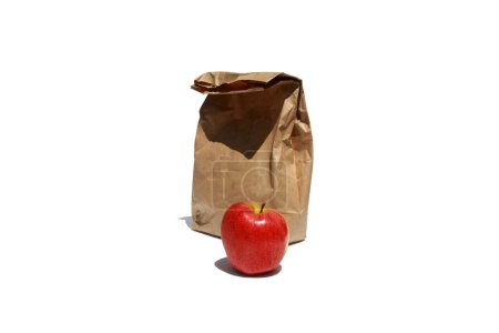 Foto de Bolsa de almuerzo de papel marrón y manzana roja aislada sobre fondo blanco - Imagen libre de derechos