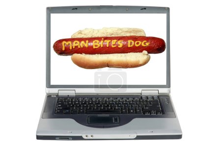 Foto de Ordenador portátil con un perro caliente con eslogan escrito en mostaza amarilla "Hombre muerde perro" - Imagen libre de derechos