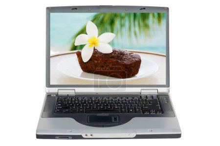 Photo for Laptop computer with banana bread. Hawaiian Banana Bread. traditional Hawaiian Banana Bread with a white Plumeria Flower on a white plate. - Royalty Free Image