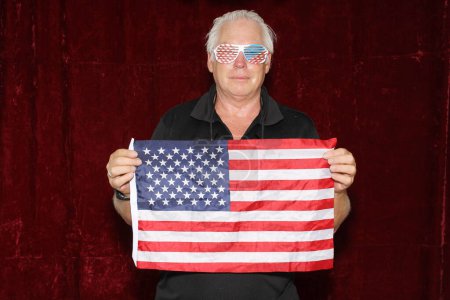 Photo for Forth of July. Photo Booth. Independence Day. American Flag Photo Booth Party. Attractive man holding Flag of the United States. - Royalty Free Image