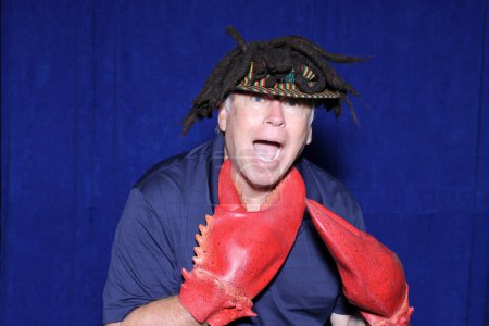Photo for A man wears Lobster Claws over his hands as he poses for pictures - Royalty Free Image