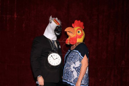Photo for Two people wear Animal Head Masks and pose for pictures while in a Photo Booth - Royalty Free Image