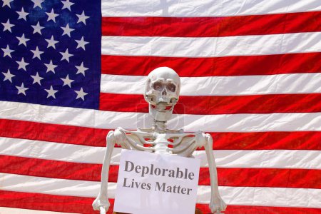 Photo for Human Skeleton holding Deplorable Lives Matter sign in a Photo booth - Royalty Free Image
