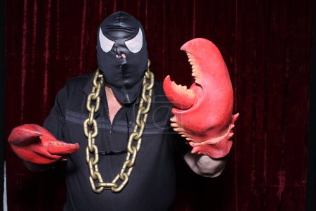 Photo for Photo Booth. Lobster Man, Hero to All Coruscations. A man poses in a Photo Booth as LOBSTER MAN. - Royalty Free Image