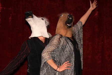 Photo for Unidentifiable People wear Horse Head Masks and pose and play while their pictures are taken in a Photo Booth - Royalty Free Image