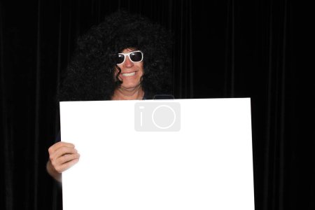 Photo for A man smiles as he holds a Blank White Sign with room for your Text or Images. - Royalty Free Image