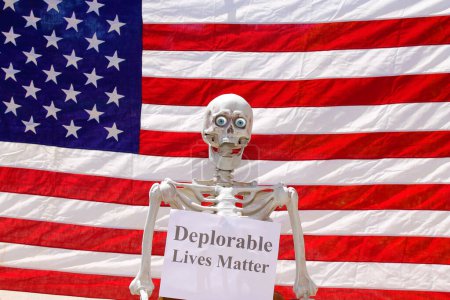 Photo for Human Skeleton holding Deplorable Lives Matter sign in a Photo booth - Royalty Free Image