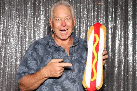 Photo for Mature male with toy hotdog - Royalty Free Image
