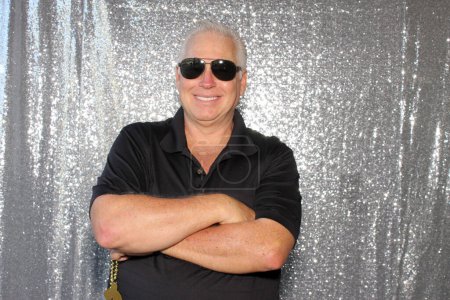 Photo for Portrait of a senior man in sunglasses with crossed arms - Royalty Free Image