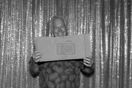Photo for Black and white photo of happy senior man with empty banner - Royalty Free Image