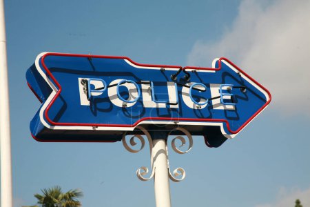Photo for Police. Neon POLICE Arrow Sign. Police Sign pointing to the Police Station. Sign with cloudy sky. Neon Sign. Blue Neon. Red Neon. Advertising. Directions. Peace Officer. Cops are very important. Cops. - Royalty Free Image