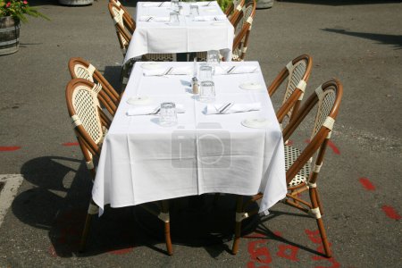 Photo for Restaurant. Outdoor Dining at a Restaurant. Table with Chairs. Outdoor Cafe. Outside Dining. Business Lunch. Lunch Date. Dinner Date. Business Dinner. Open Air Restaurant. Outdoor Service. Lunch Time - Royalty Free Image