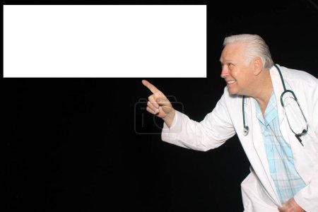 Photo for A Doctor smiles and points to a box with your message, text or images as he waits for his pictures to be taken while enjoying a Photo Booth. - Royalty Free Image