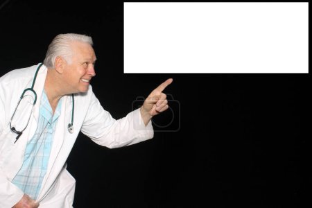 Photo for A Doctor smiles and points to a box with your message, text or images as he waits for his pictures to be taken while enjoying a Photo Booth. - Royalty Free Image