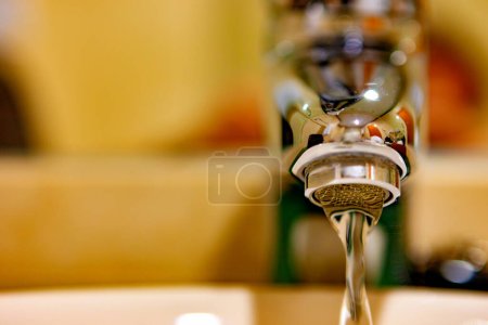 Photo for Water tap at home. Running water in bathroom with sink.Concept of water savings and sustainability. - Royalty Free Image