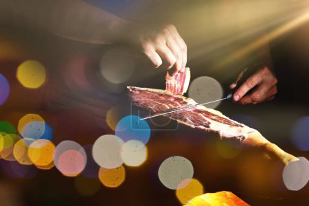 Photo for Slicing Spanish beric ham. Spanish jamon and traditional food.Dry Spanish ham, Jamon Serrano, Bellota, Italian Prosciutto Crudo or Parma ham. - Royalty Free Image