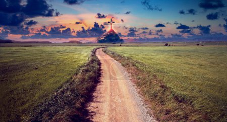 Photo for Landscape of crop fields and grassy meadows at sunset and road or path to the mountain with cross on top. Concept of the journey towards destiny and spirituality. - Royalty Free Image