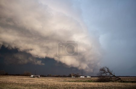 Photo for A huge storm with a shelf cloud approaches rapidly over a farmland landscape - Royalty Free Image