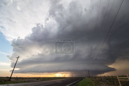 Photo for A supercell storm towers over a lonely highway in the plains. - Royalty Free Image