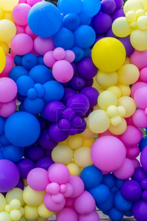 Photo for Bright abstract background of jumble of rainbow colored balloons, celebrating. - Royalty Free Image