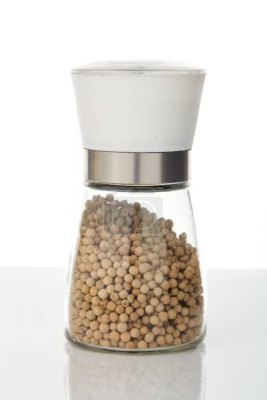 Photo for White pepper in a glass jar on white background - Royalty Free Image