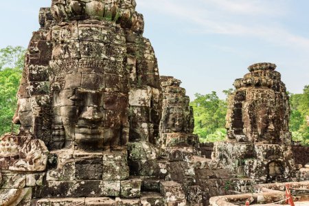 Photo for Giant stone faces of ancient Bayon temple. Bayon temple nestled in Angkor Thom, Siem Reap, Cambodia. Angkor Thom is a popular tourist attraction. - Royalty Free Image