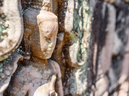 Photo for Wall sculpture in ancient Preah Khan temple in amazing Angkor in morning sun. Siem Reap, Cambodia. Enigmatic Preah Khan nestled among rainforest. Angkor is a popular tourist attraction. - Royalty Free Image