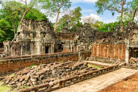Mysterious ruins of ancient Preah Khan temple in amazing Angkor in morning sun. Siem Reap, Cambodia. Enigmatic Preah Khan nestled among rainforest. Angkor is a popular tourist attraction.