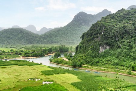 Awesome aerial view of the Son River at Phong Nha-Ke Bang National Park in Vietnam. Landscape formed by karst towers and rice fields. The national park is a popular tourist attraction of Asia.