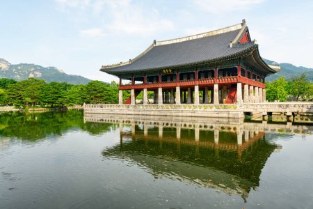 Gyeonghoeru Pavilion at Gyeongbokgung Palace in Seoul, South Korea. Sign "Royal Banquet Hall" on building of traditional Korean architecture. The pavilion reflected in water of artificial lake.