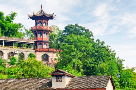 Photo for Scenic octagonal tower among green trees in Phoenix Ancient Town (Fenghuang County), China. Fenghuang is a popular tourist destination of Asia. - Royalty Free Image