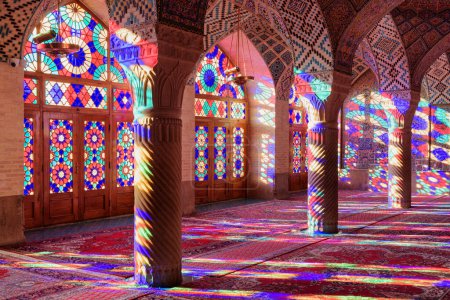 Photo for Shiraz, Iran - 31 October, 2018: Amazing morning view of prayer hall at the Nasir al-Mulk Mosque (Pink Mosque). Sunlight reflected through stained glass windows on columns, the wall and the floor. - Royalty Free Image