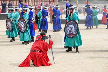 Photo for Seoul, South Korea - October 9, 2017: Performance with historical reconstruction at courtyard of Gyeongbokgung Palace. Royal guards wearing the Jeonbok, Korean traditional military clothing. - Royalty Free Image