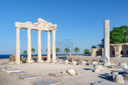 Photo for Awesome ruins of the Temple of Apollo on the Mediterranean Sea coast in Side, Turkey. The Roman temple is a popular tourist attraction in Turkey. Amazing view of columns on sunny day. - Royalty Free Image
