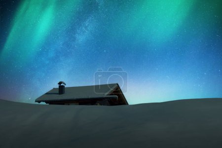 Photo for Fantastic winter landscape with wooden cabin in snowy mountains and northen light in night sky. Christmas holiday and winter vacations concept - Royalty Free Image