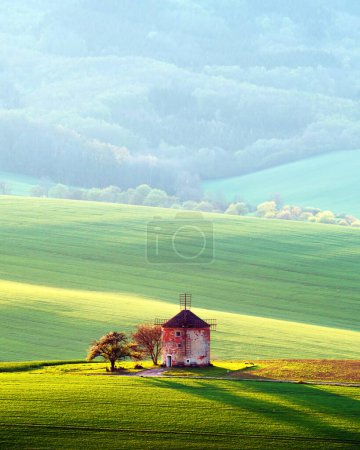 Photo for Picturesque rural landscape with old windmill and green sunny spring hills. South Moravia region, Czech Republic - Royalty Free Image
