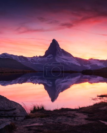 Photo for Picturesque landscape with colorful sunrise on Stellisee lake. Snowy Matterhorn Cervino peak with reflection in clear water. Zermatt, Swiss Alps - Royalty Free Image