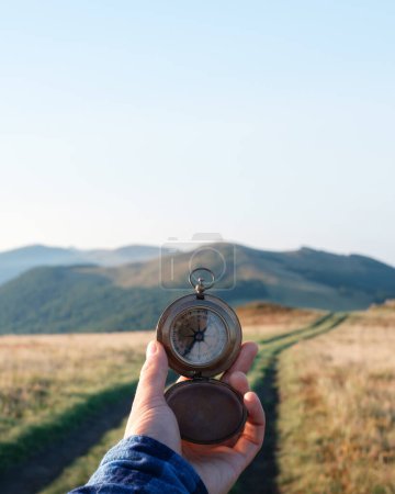 Photo for Man with compass in hand on mountains road. Travel concept. Landscape photography - Royalty Free Image