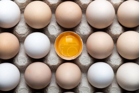 Photo for Chicken eggs in organic packaging closeup. Egg half broken among other eggs. Food photography - Royalty Free Image