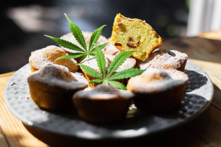 Photo for Sweet cupcakes with cannabis on plate. Dessert cake with marijuana close up. Cooking baking cakes with medical weed. Food photography - Royalty Free Image
