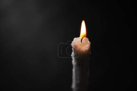 Photo for Close-up of a lighting candle on the dark background - Royalty Free Image