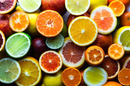 Photo for A close-up arrangement of assorted citrus fruits, embodying the concept of a nutritious and vitamin-rich diet. Food background. Natural texture - Royalty Free Image