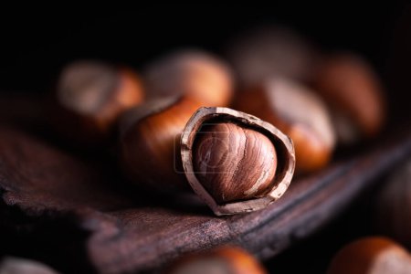 Photo for Hazelnut nuts close up. Cracked hazelnut with kernel inside. Food photography. Macro shot - Royalty Free Image