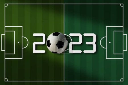 Vue du dessus du ballon de football sur le terrain de football avec le numéro 2023. Concept de tournoi.
