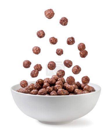 Foto de Bolas de maíz de chocolate cayendo en un primer plano plato sobre un fondo blanco. Aislado - Imagen libre de derechos